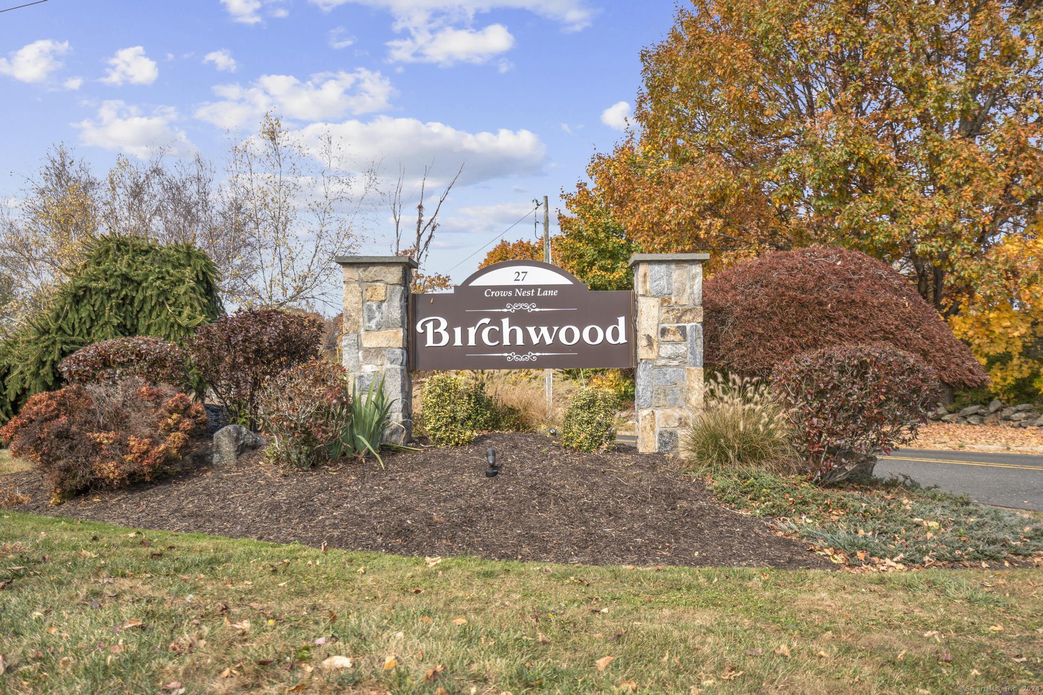 a sign board with buildings in the background