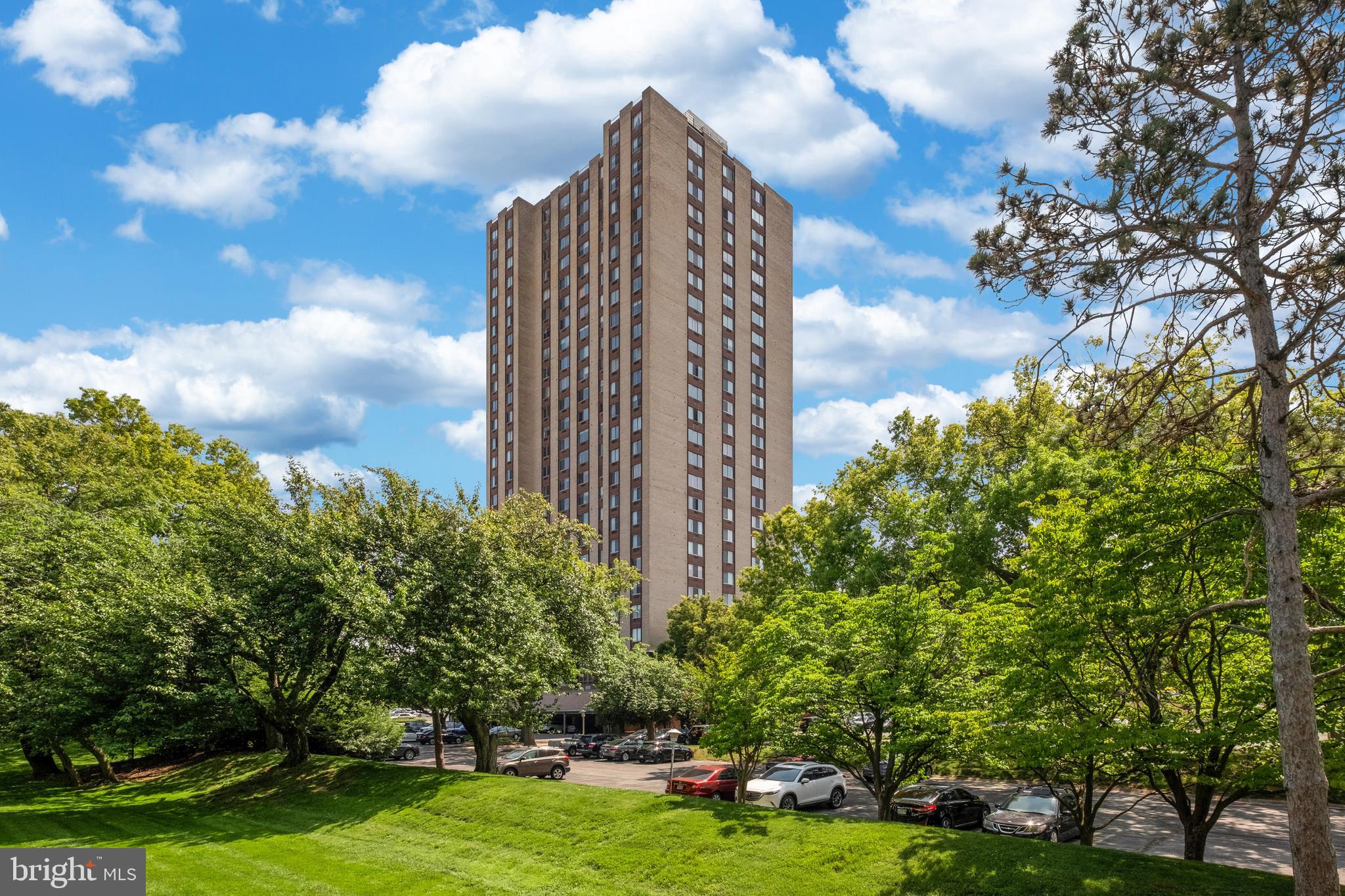 a view of a large building with a big yard and large trees