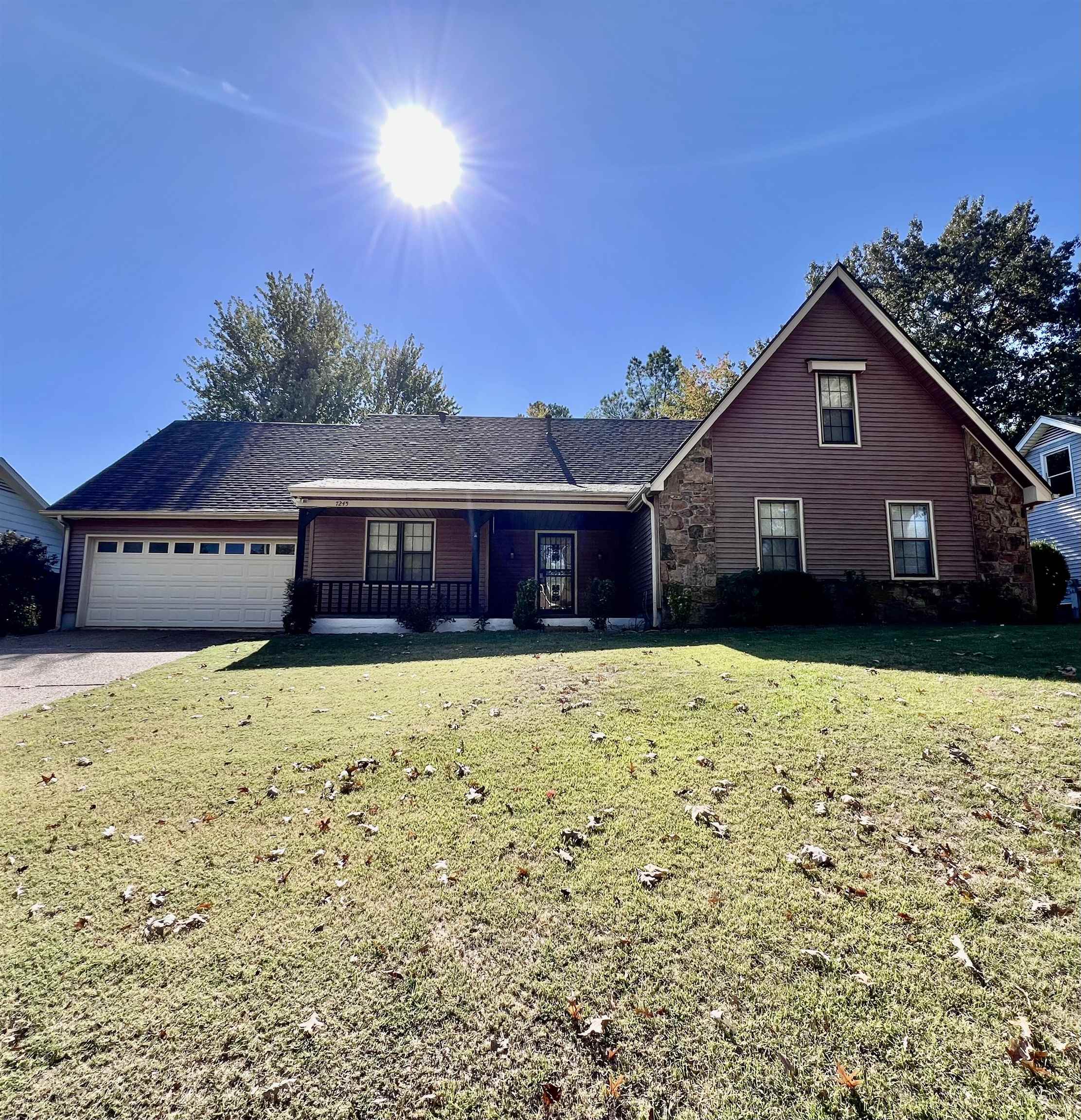 Front facade featuring a front lawn and a garage