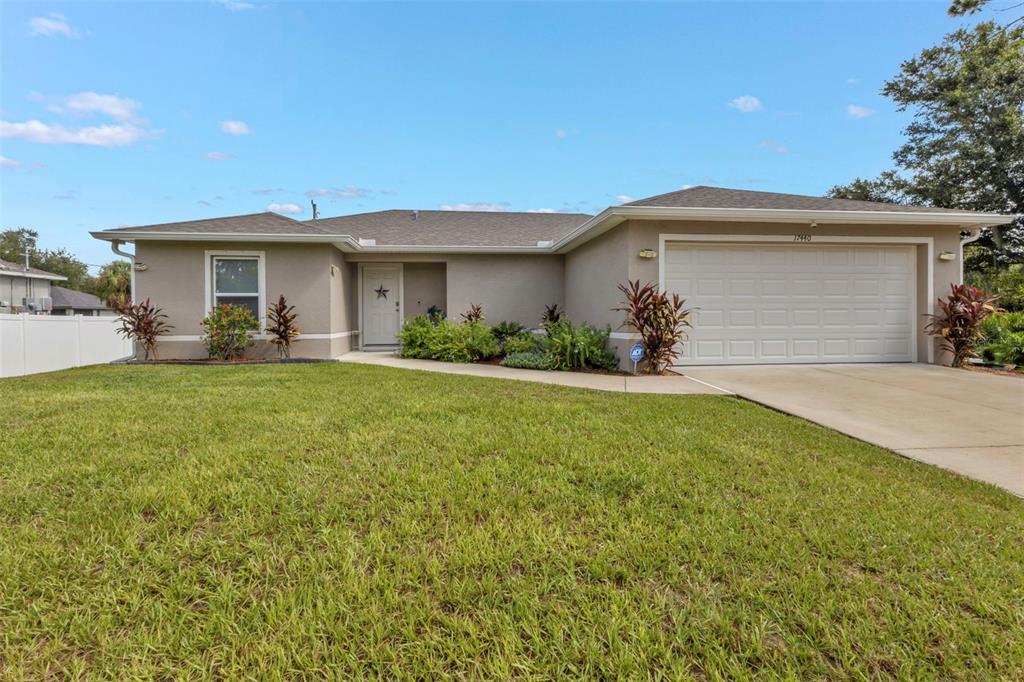 a front view of a house with a yard and garage