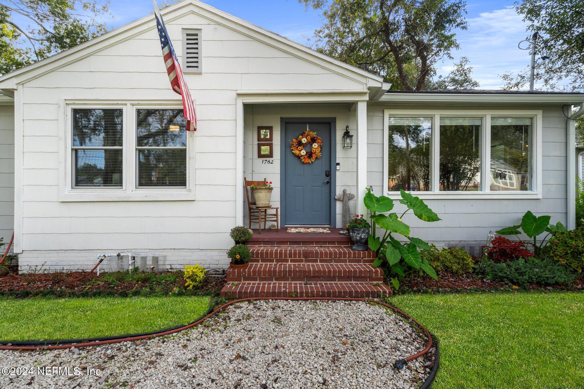 a front view of a house with a garden