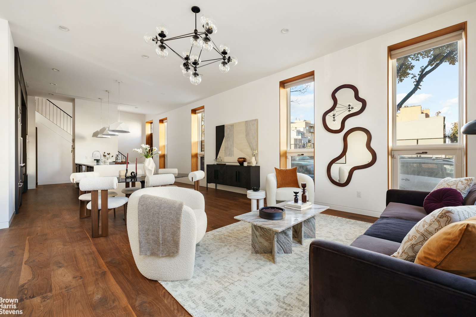 a living room with patio furniture and a chandelier