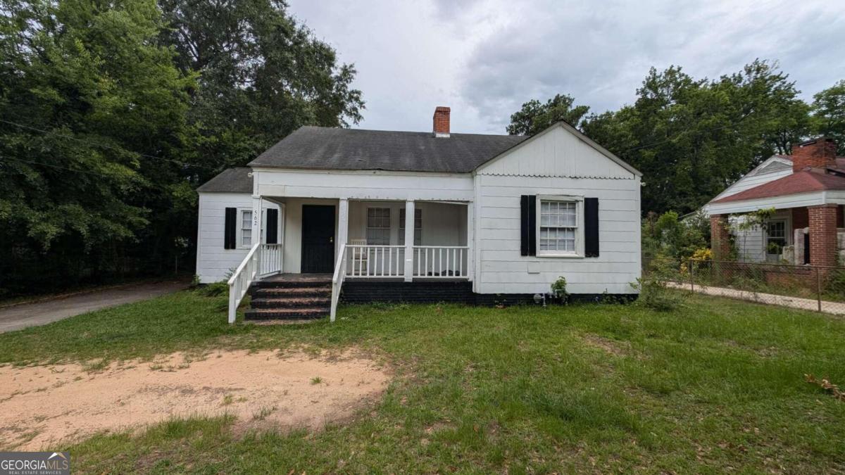 a front view of a house with a garden