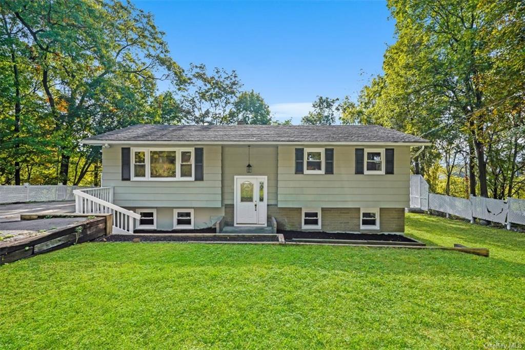 a view of a house with a backyard and a patio