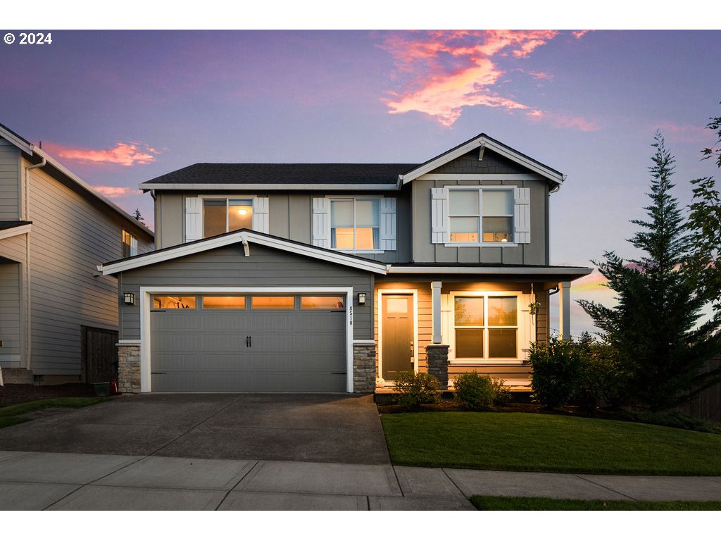 a front view of a house with a yard and garage