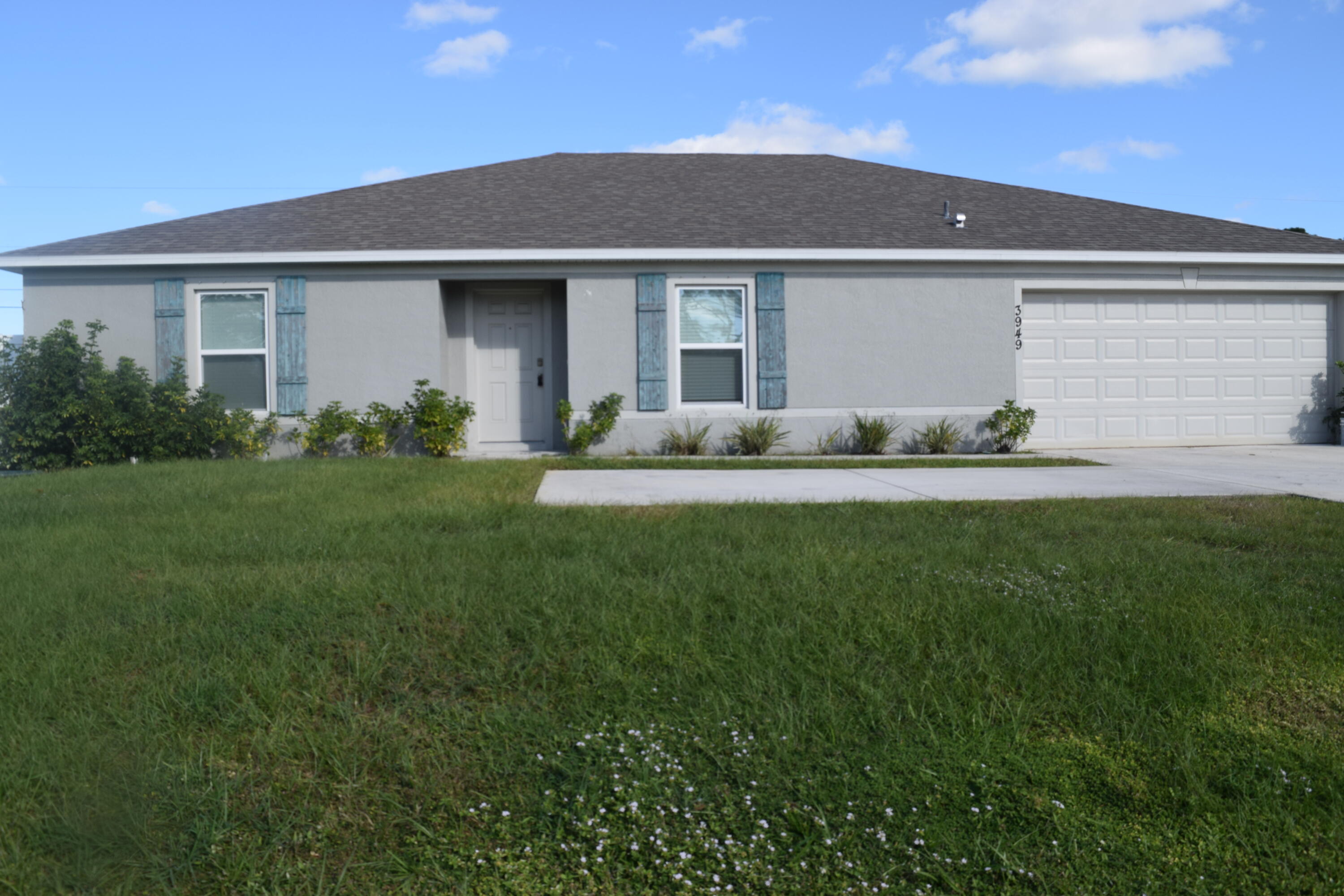 a front view of house with yard and green space