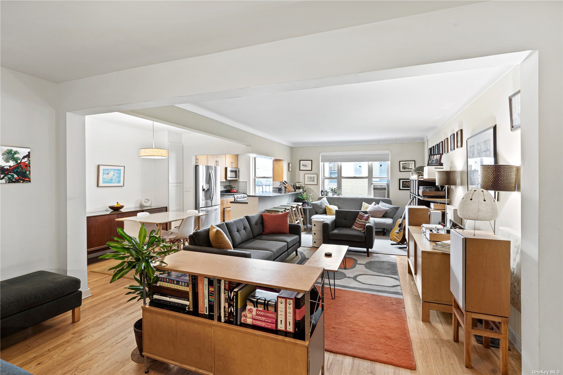 a living room with lots of furniture and a wooden floor