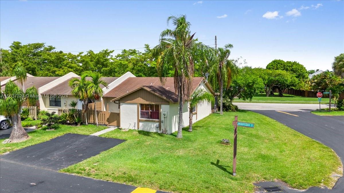 a house that has a tree in front of it