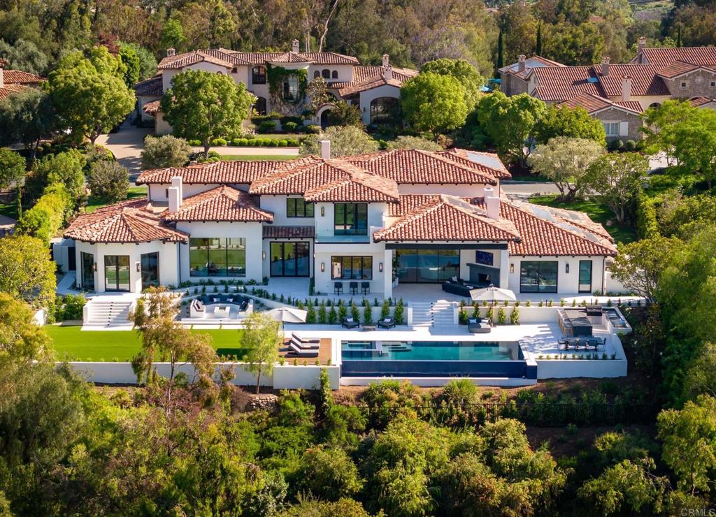 a front view of a house with swimming pool patio and fire pit