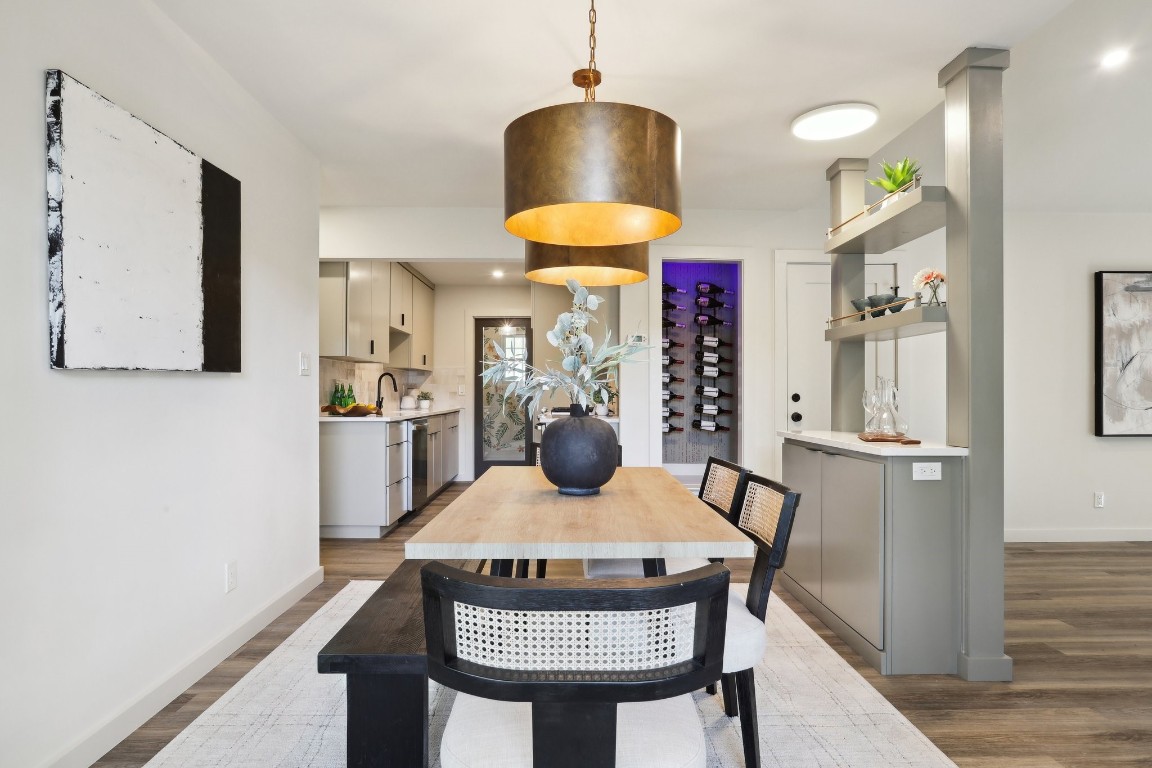 a view of a kitchen area with furniture and wooden floor