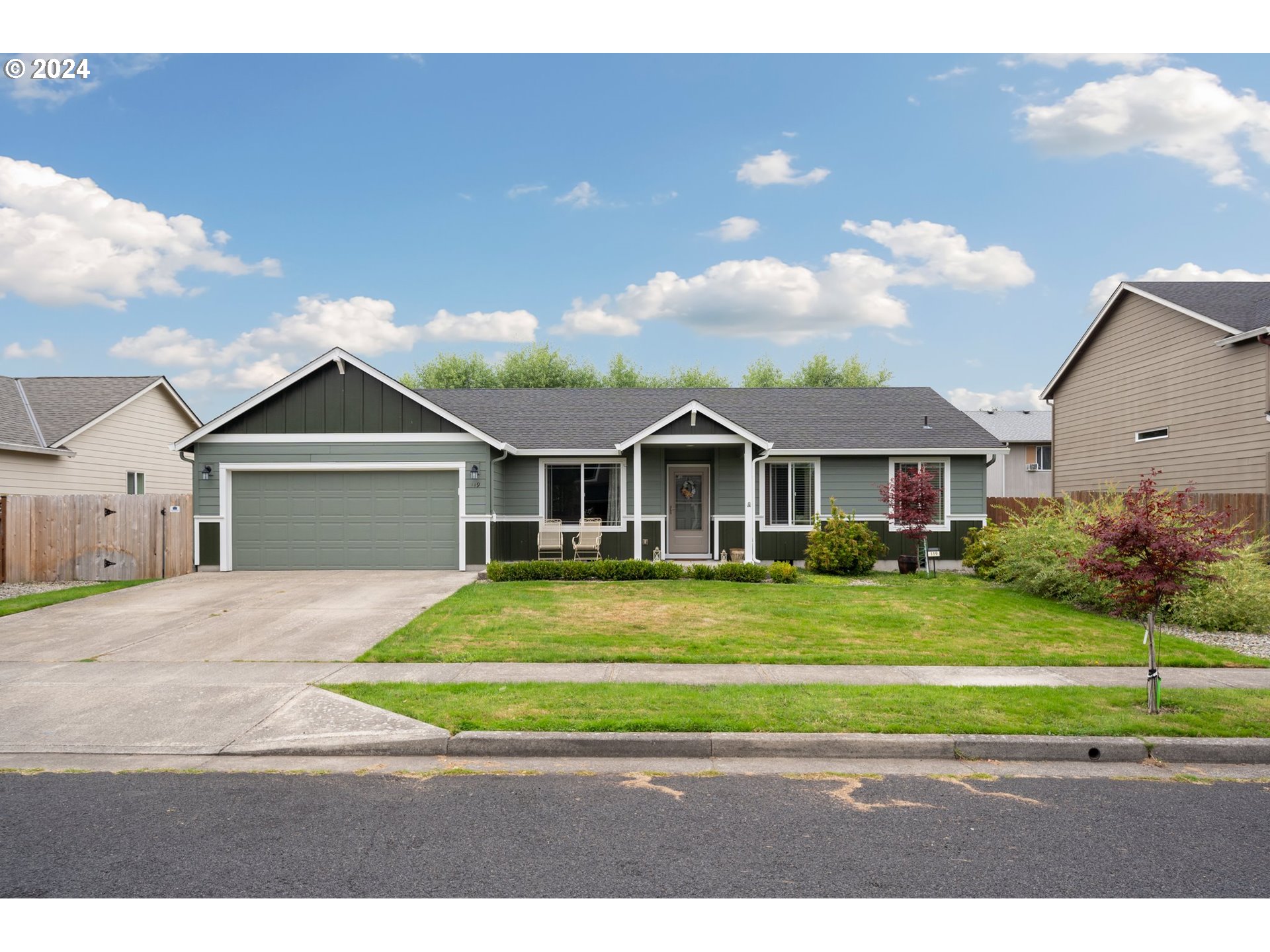 a front view of a house with a yard and garage