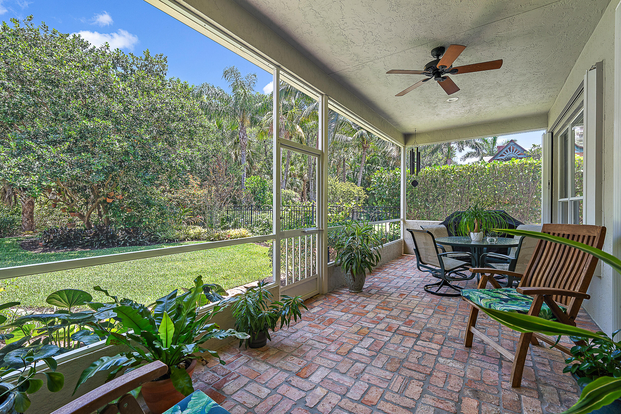 a view of a porch with furniture and a yard