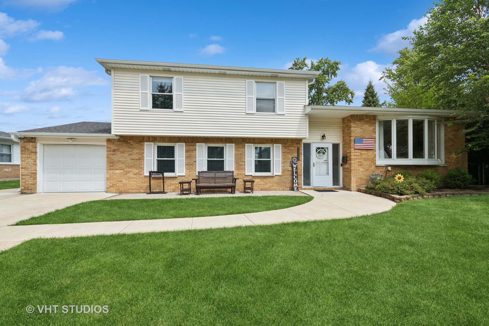 a front view of house with yard and green space