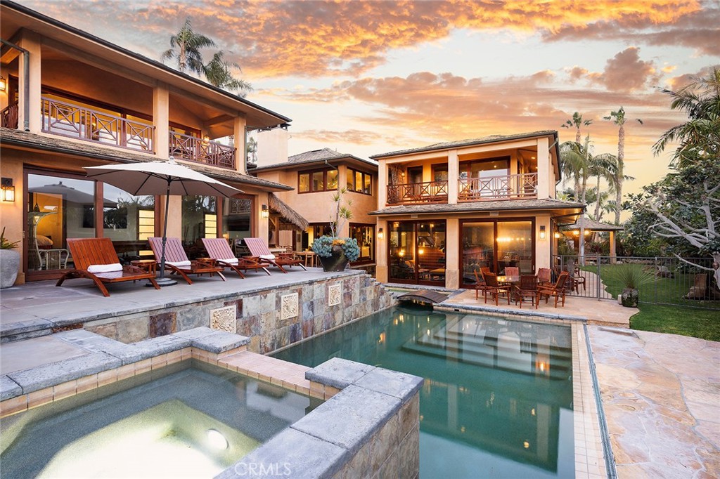 a view of an house with swimming pool and sitting area