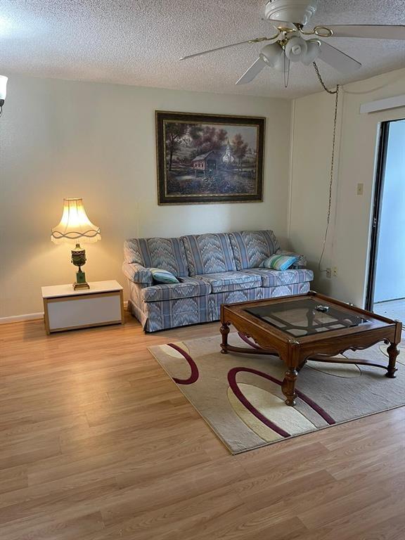 a living room with furniture flat screen tv and lamp