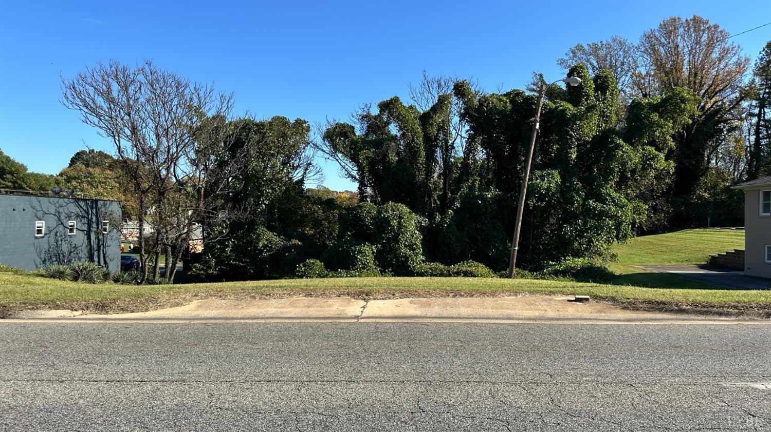 a view of a house with a yard and a palm tree