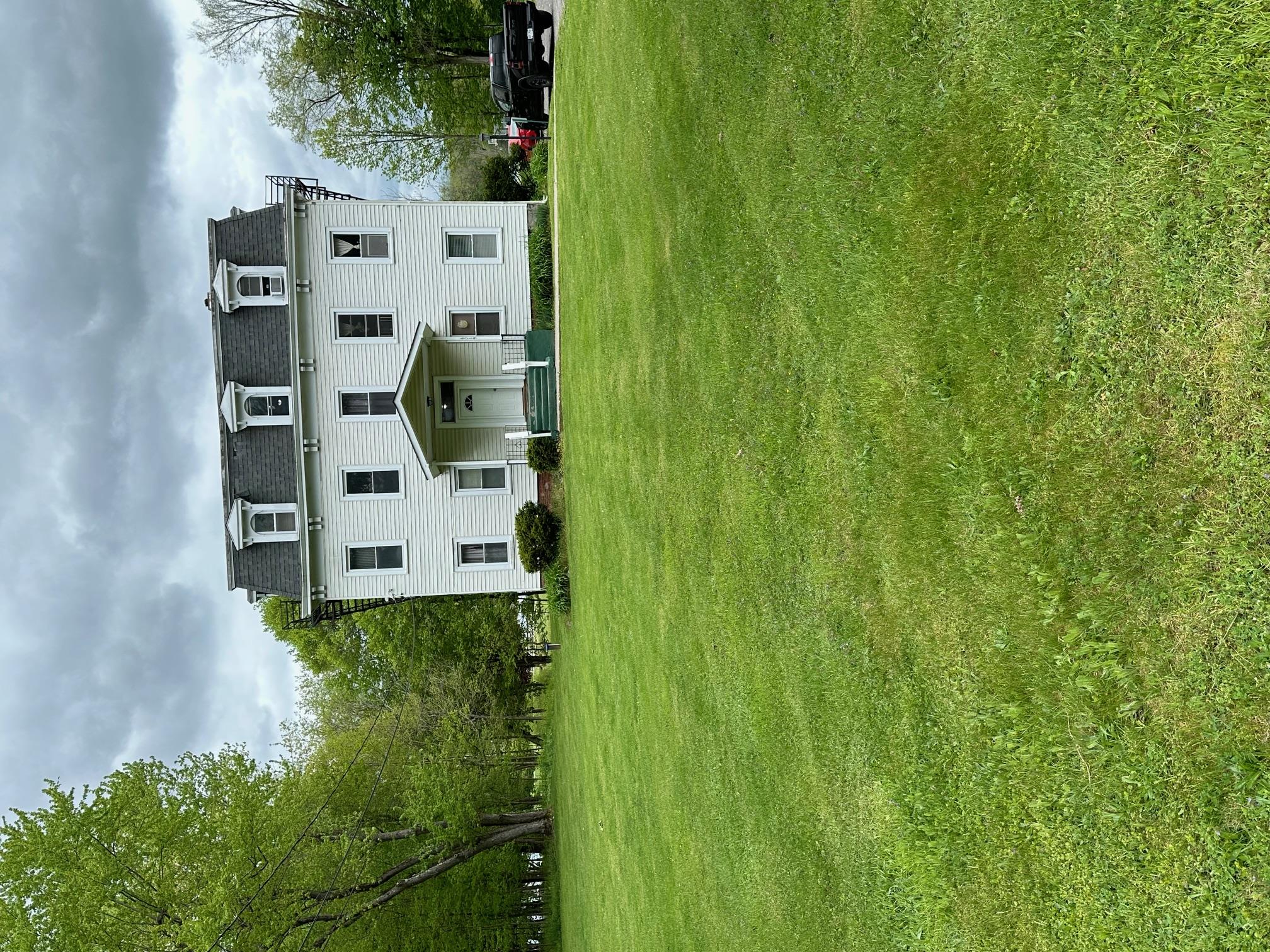 a large building with a big yard and large trees