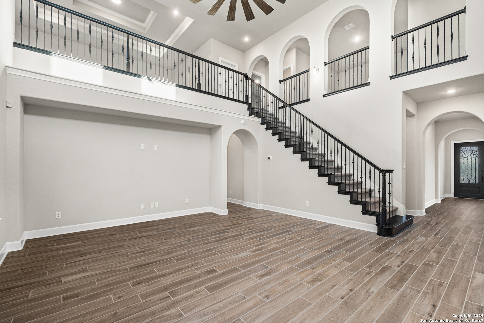 a view of entryway and hall with wooden floor