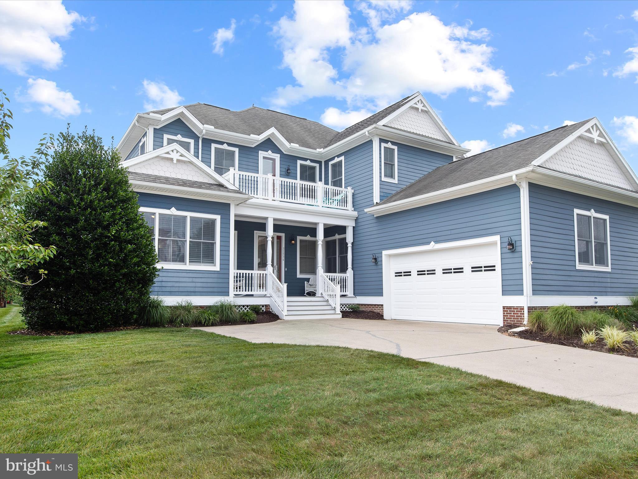 a front view of a house with a garden and yard