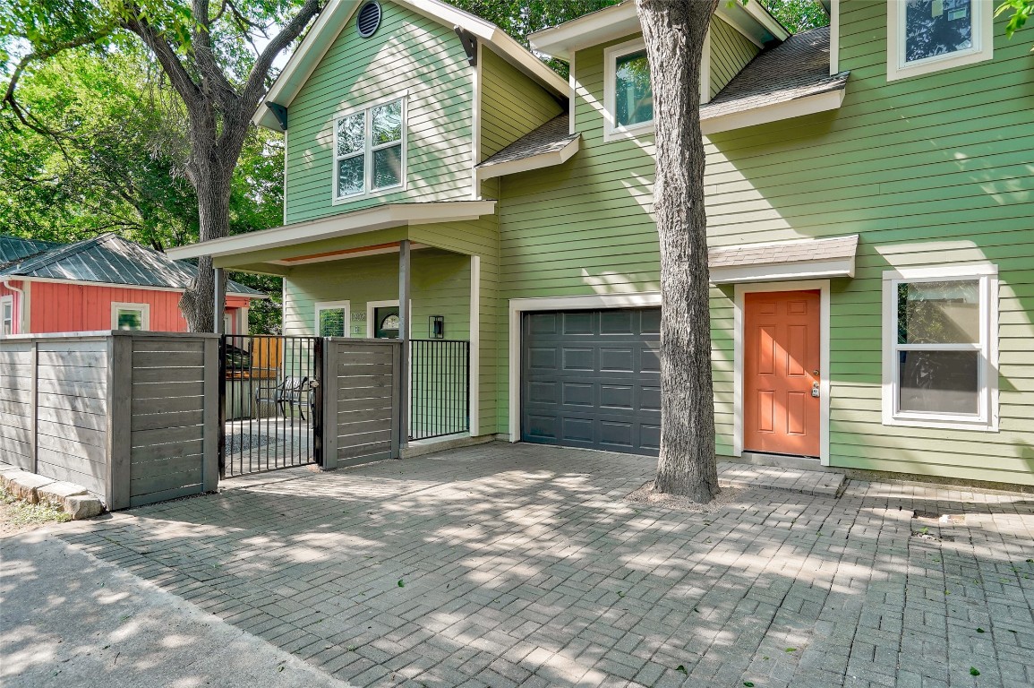 a view of a house with a garage and wooden fence