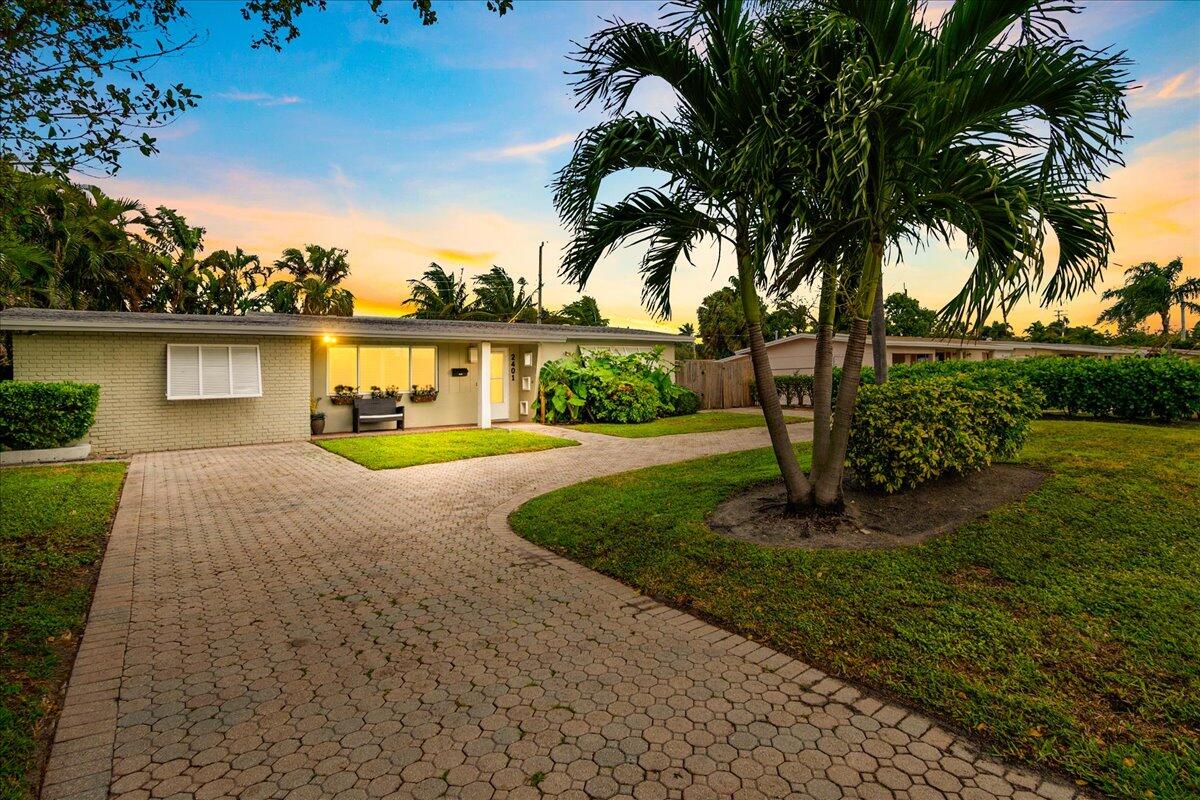 a front view of house with yard and green space