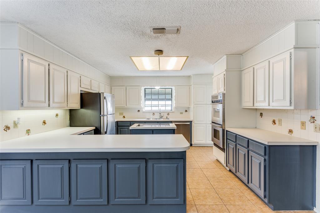 a kitchen with stainless steel appliances a sink stove and cabinets