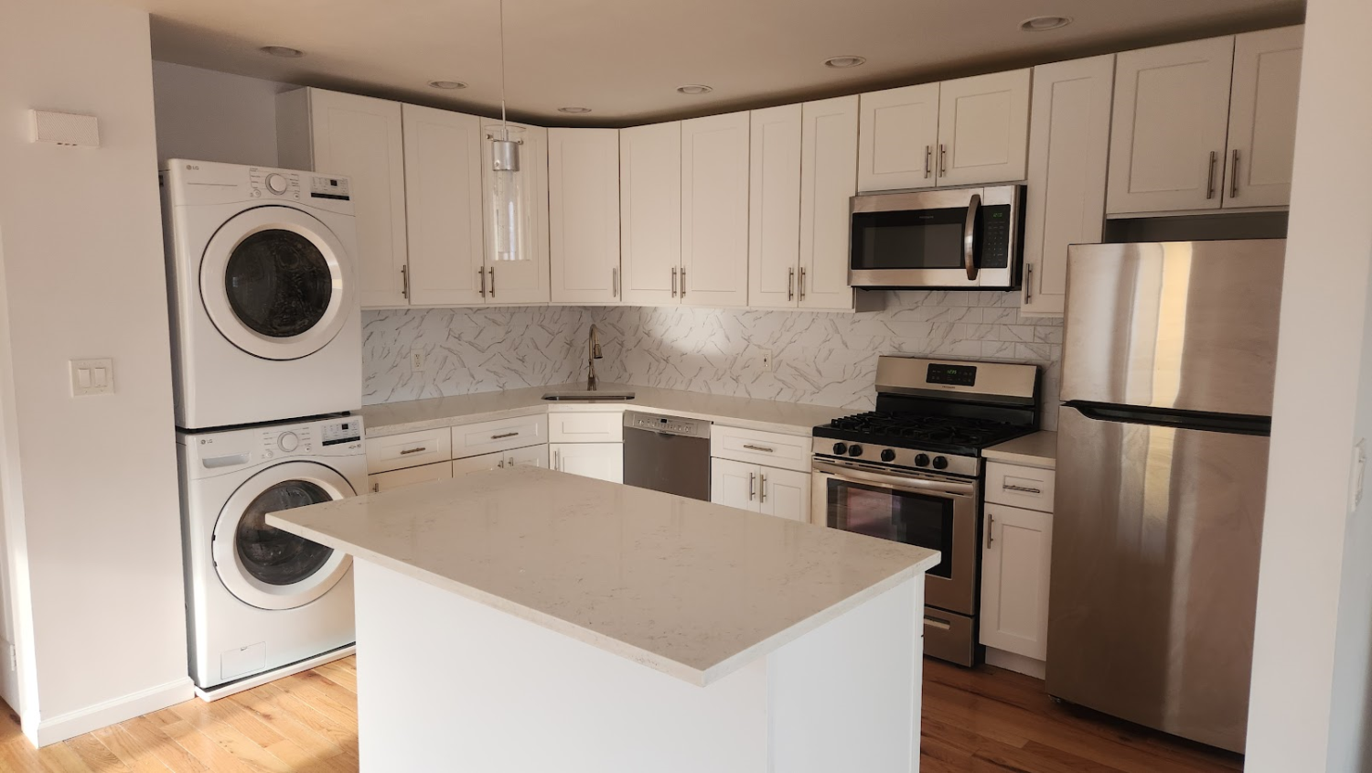 a kitchen with a sink a stove top oven and refrigerator