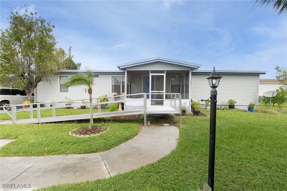 a view of a house with a yard patio and swimming pool