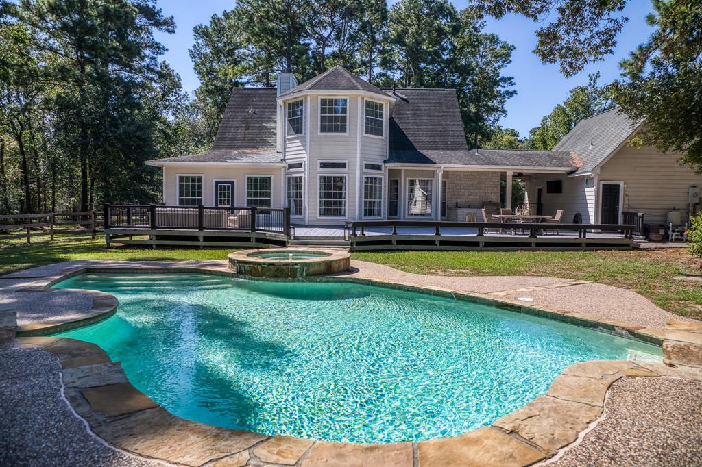 a view of a house with swimming pool and yard