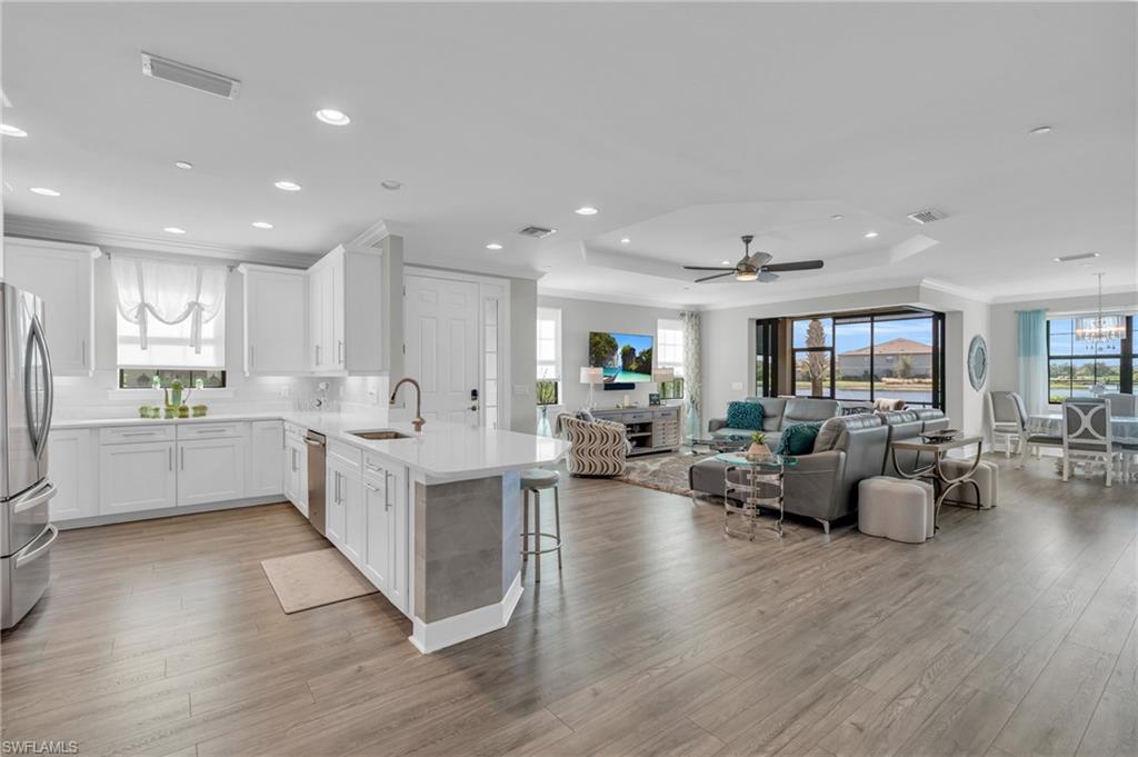 a kitchen with white cabinets and counter space