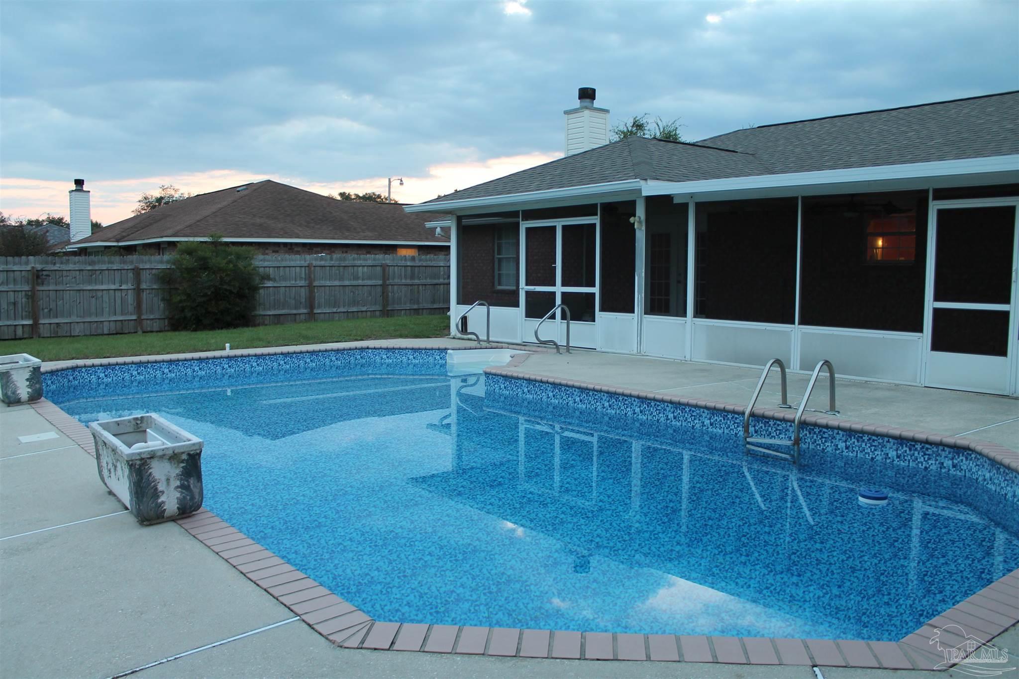 a view of a house with a backyard and porch