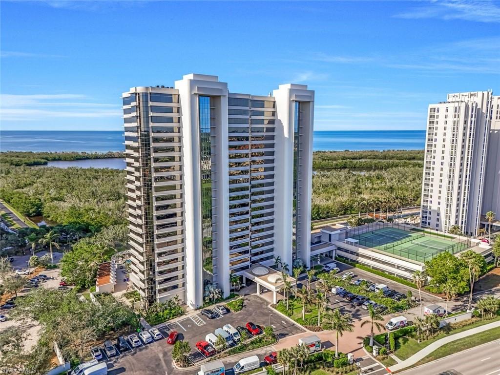 Birds eye view of property with a water view