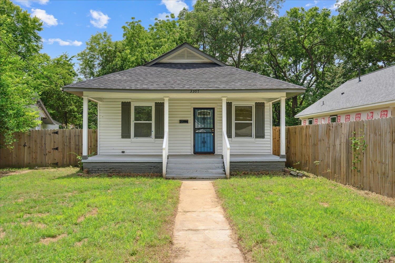 Bungalow-style home with a porch and a front lawn