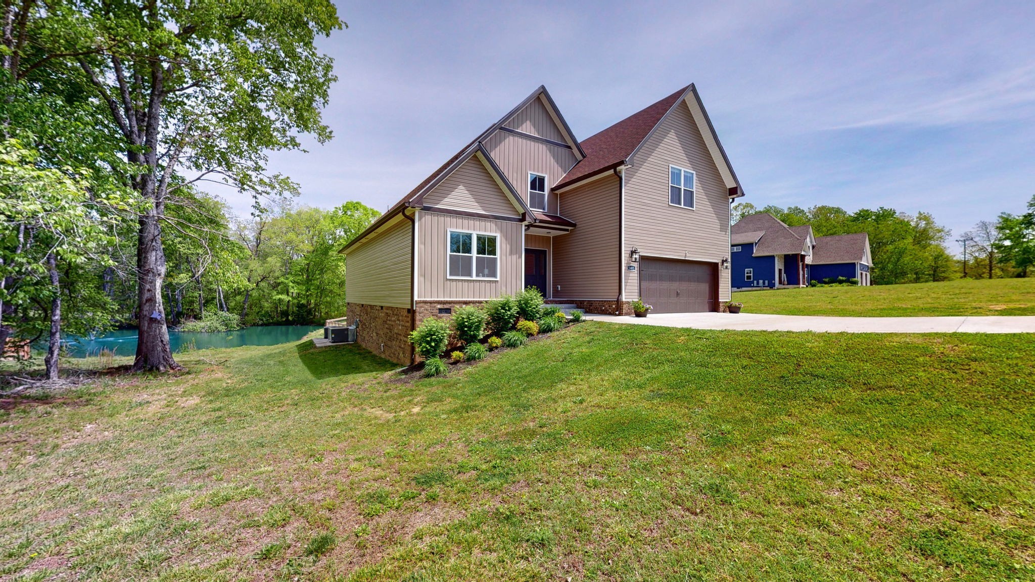 a front view of house with yard and green space