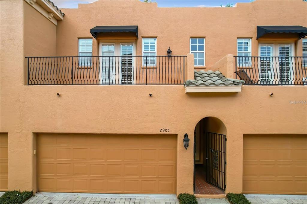 a front view of a house with wooden fence