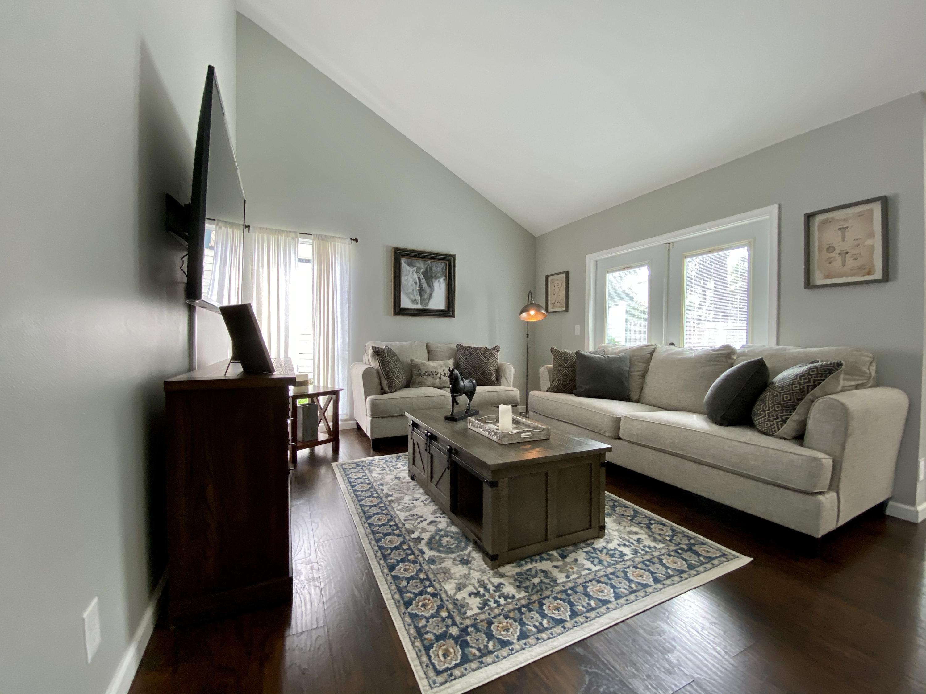 a living room with furniture and a flat screen tv