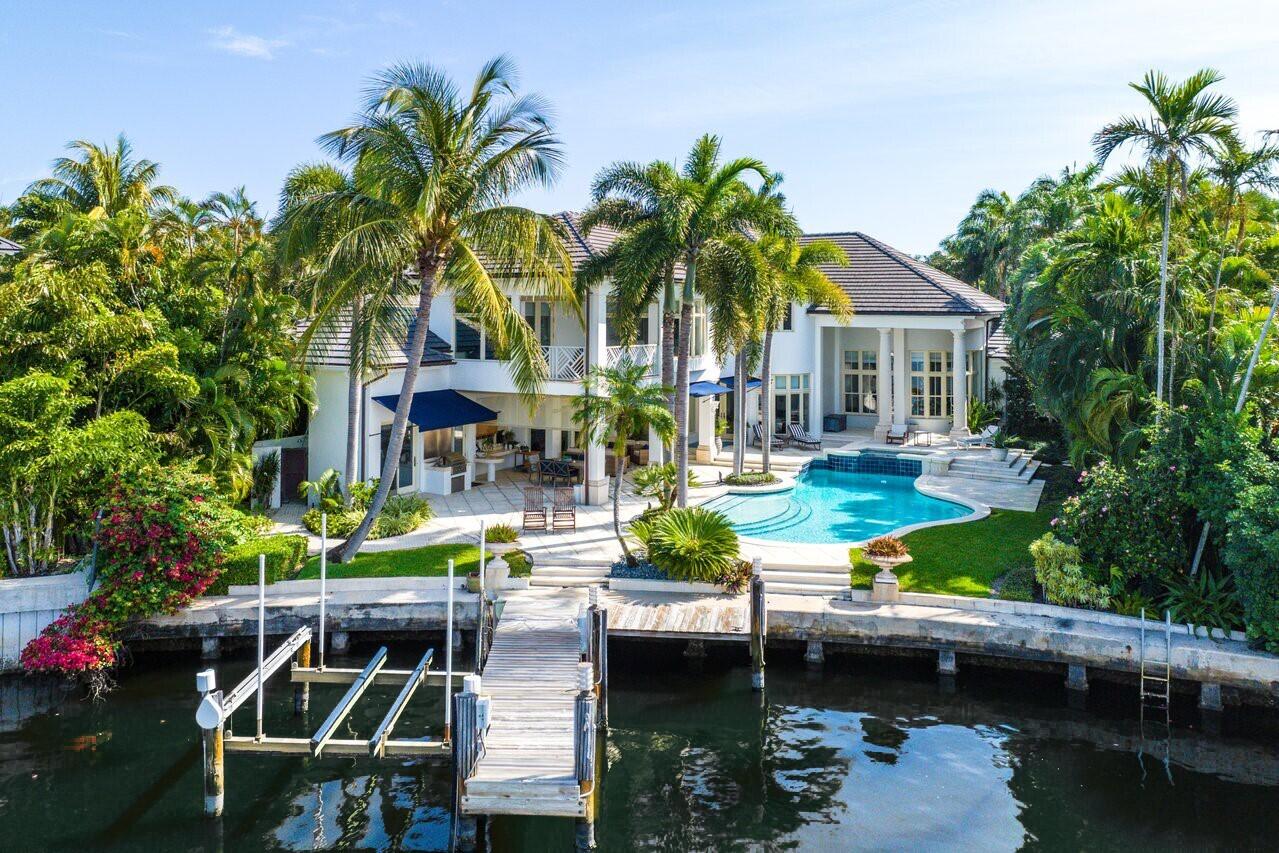 a view of house with swimming pool and outdoor seating