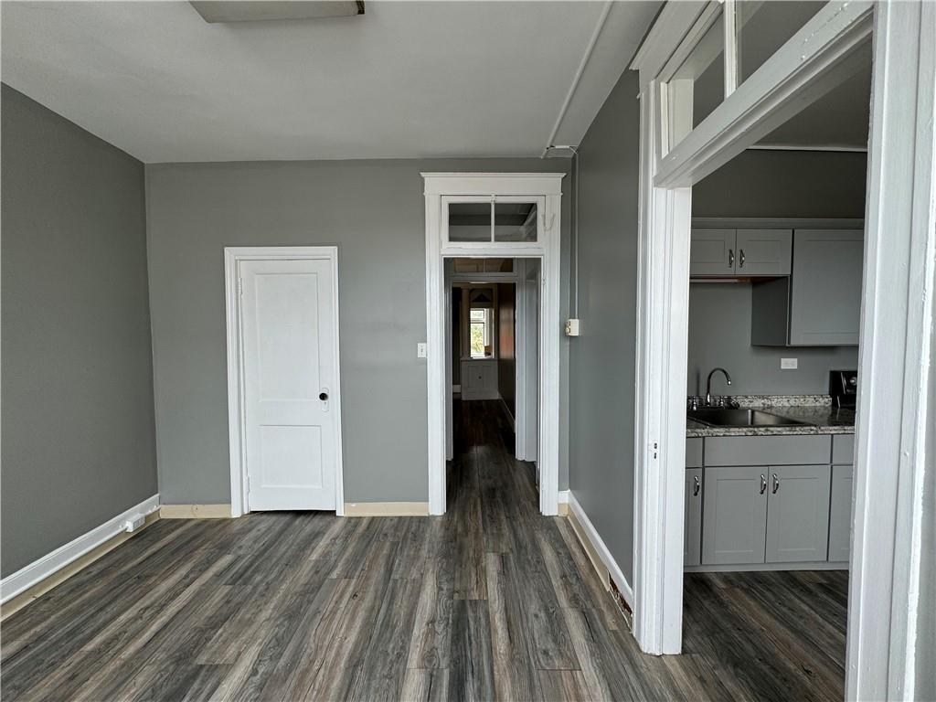 a view of wooden floor and windows in a room