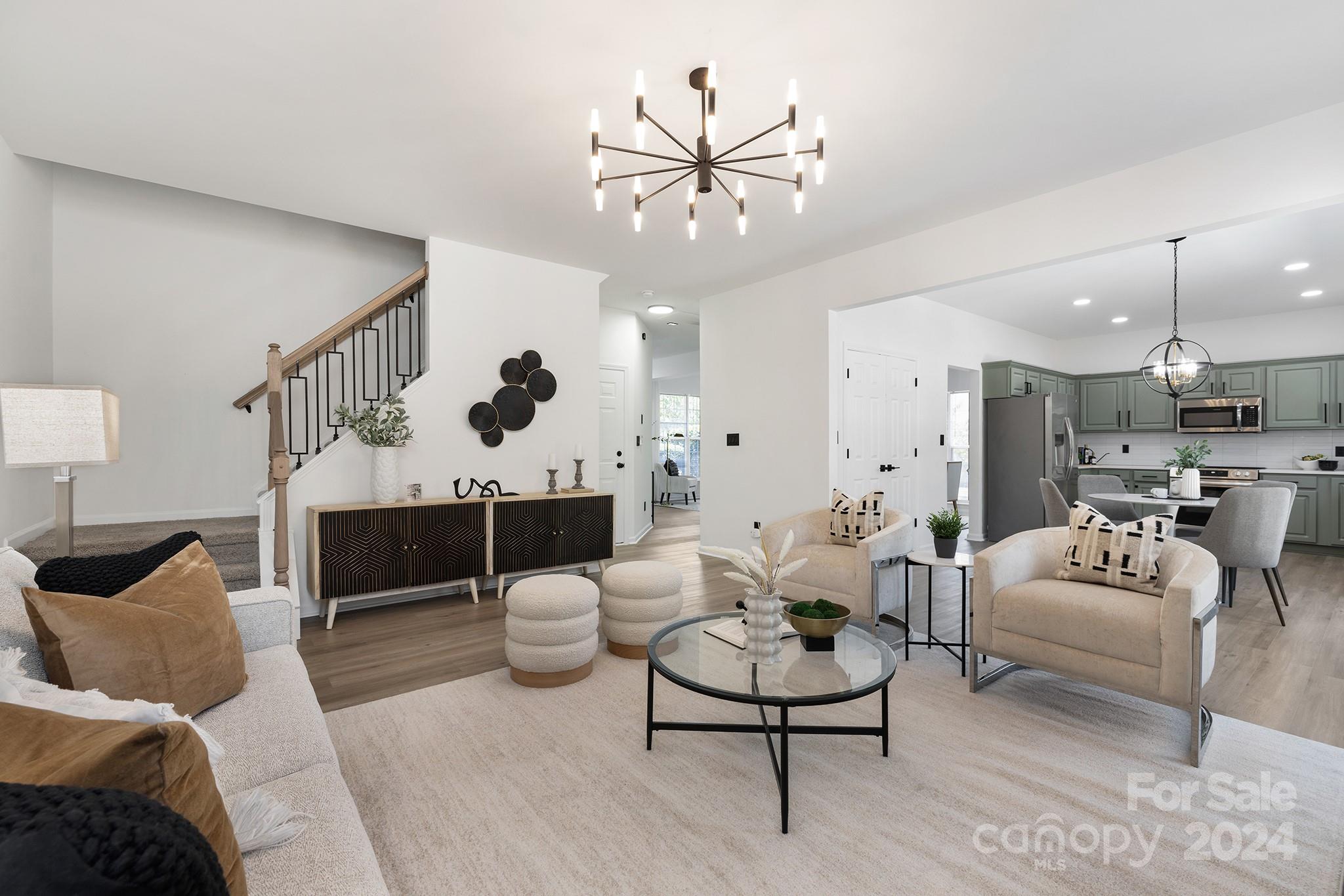 a living room with furniture and a chandelier