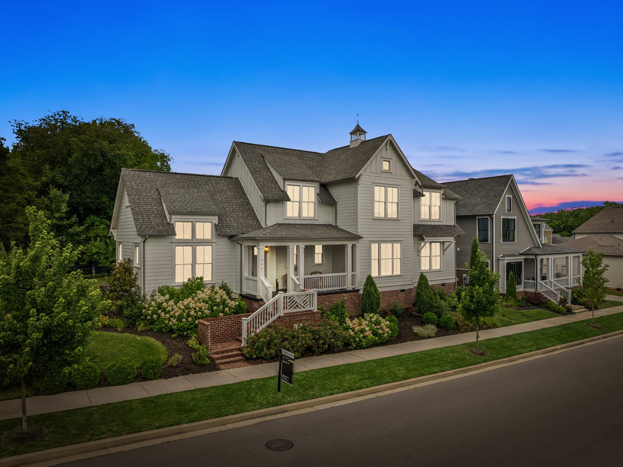 a front view of a house with a garden