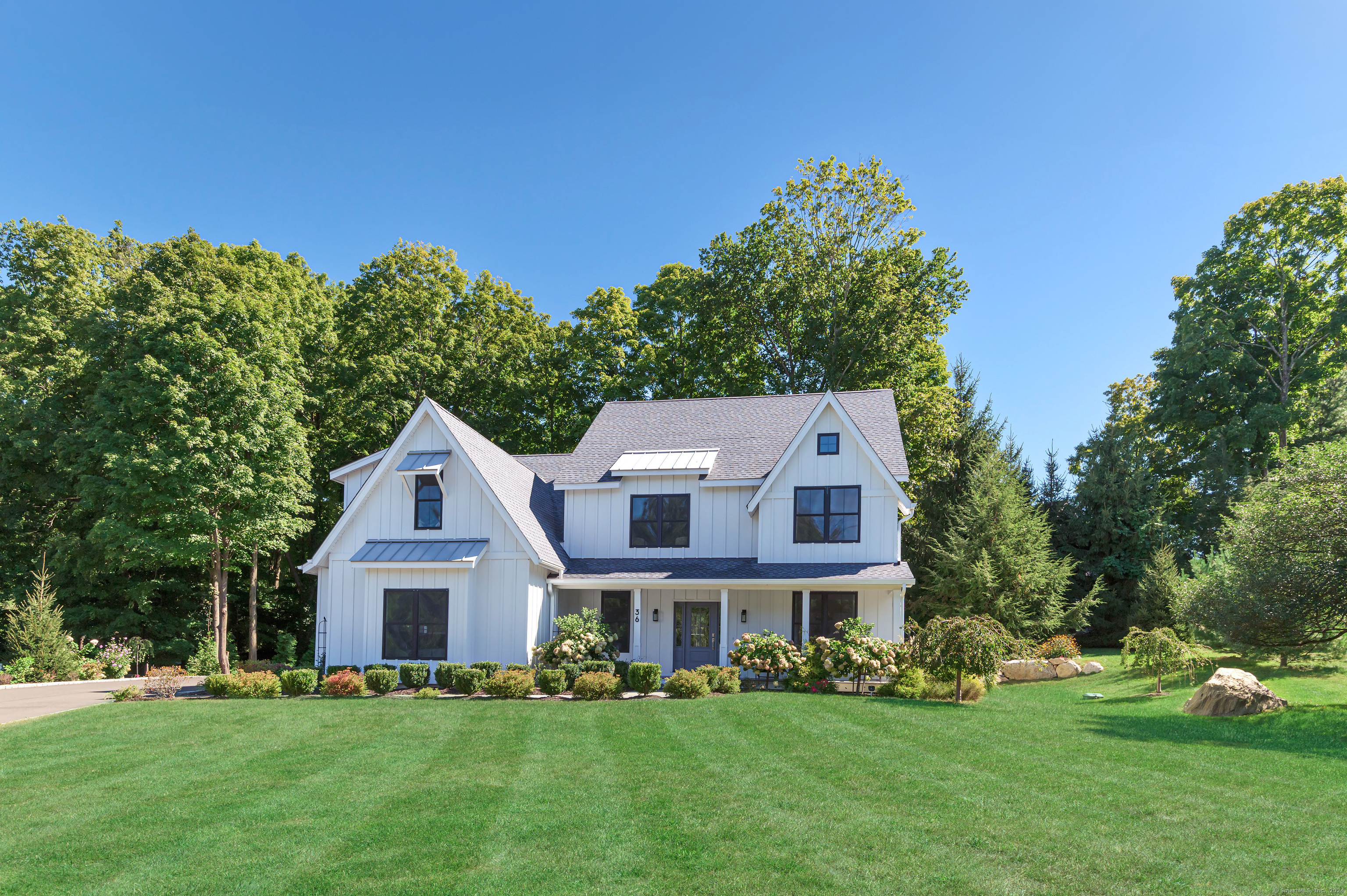 a front view of a house with a garden