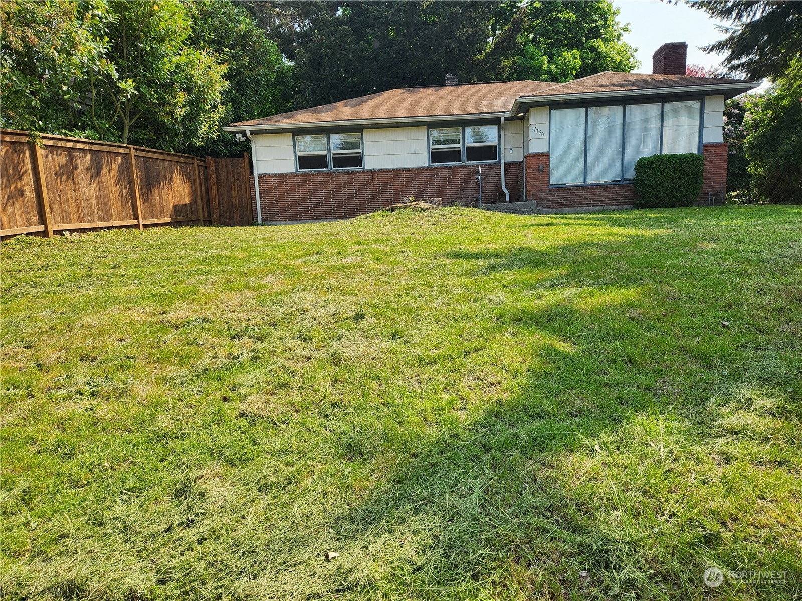 a view of a house with a yard and deck