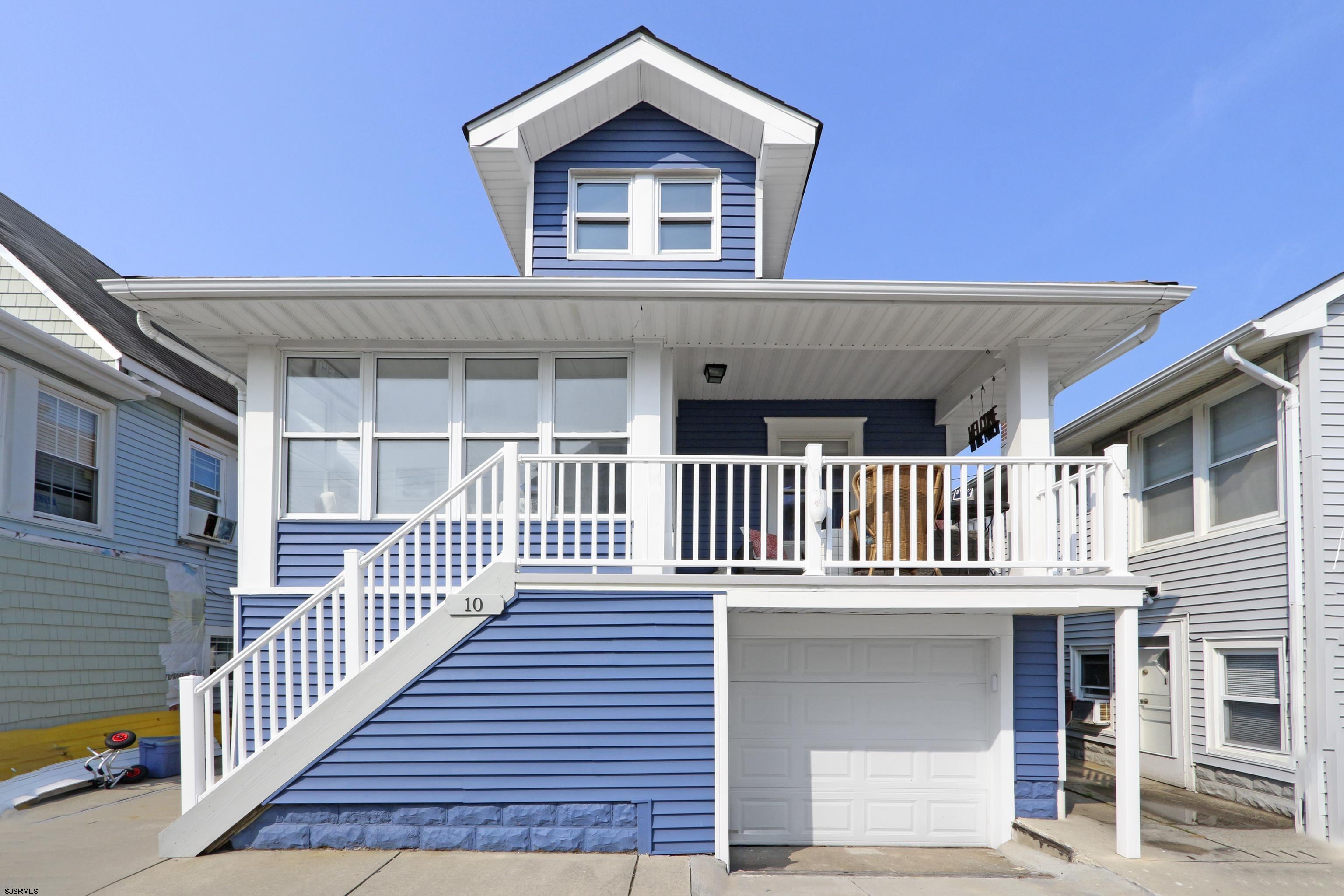 a view of a house with deck and a yard