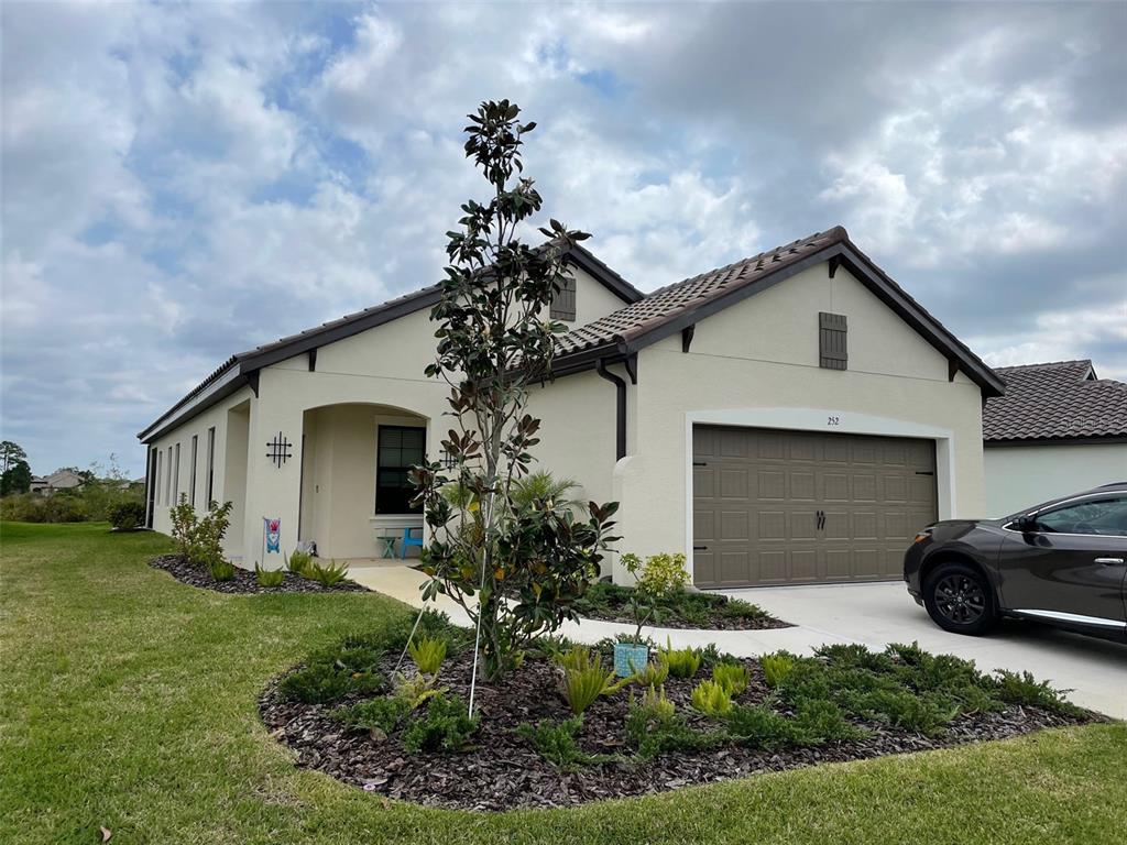 a front view of a house with garden