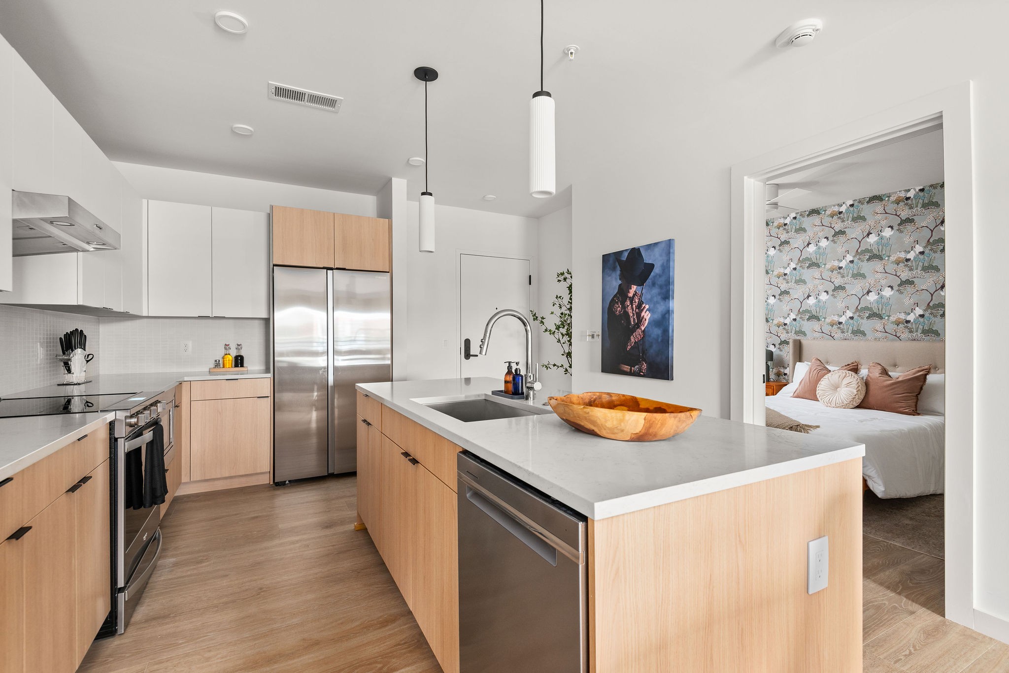 a kitchen with stainless steel appliances granite countertop a sink and a stove with white cabinets