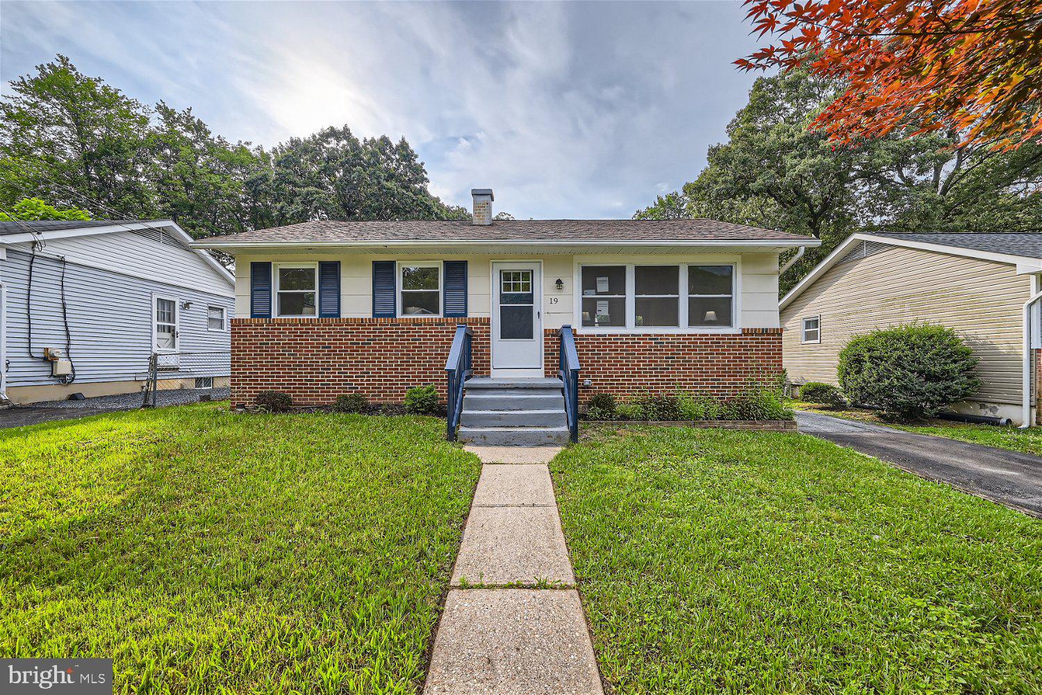 a front view of a house with a garden and yard