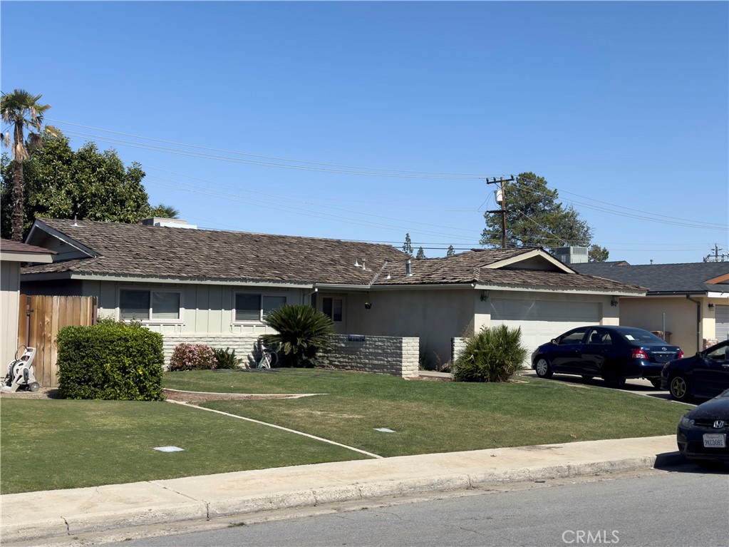 a front view of a house with a garden and plants