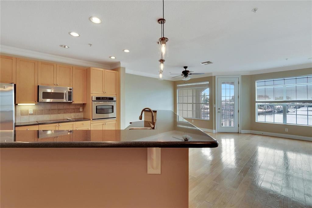 a kitchen with stainless steel appliances granite countertop a sink a stove and a granite counter tops with white countertops