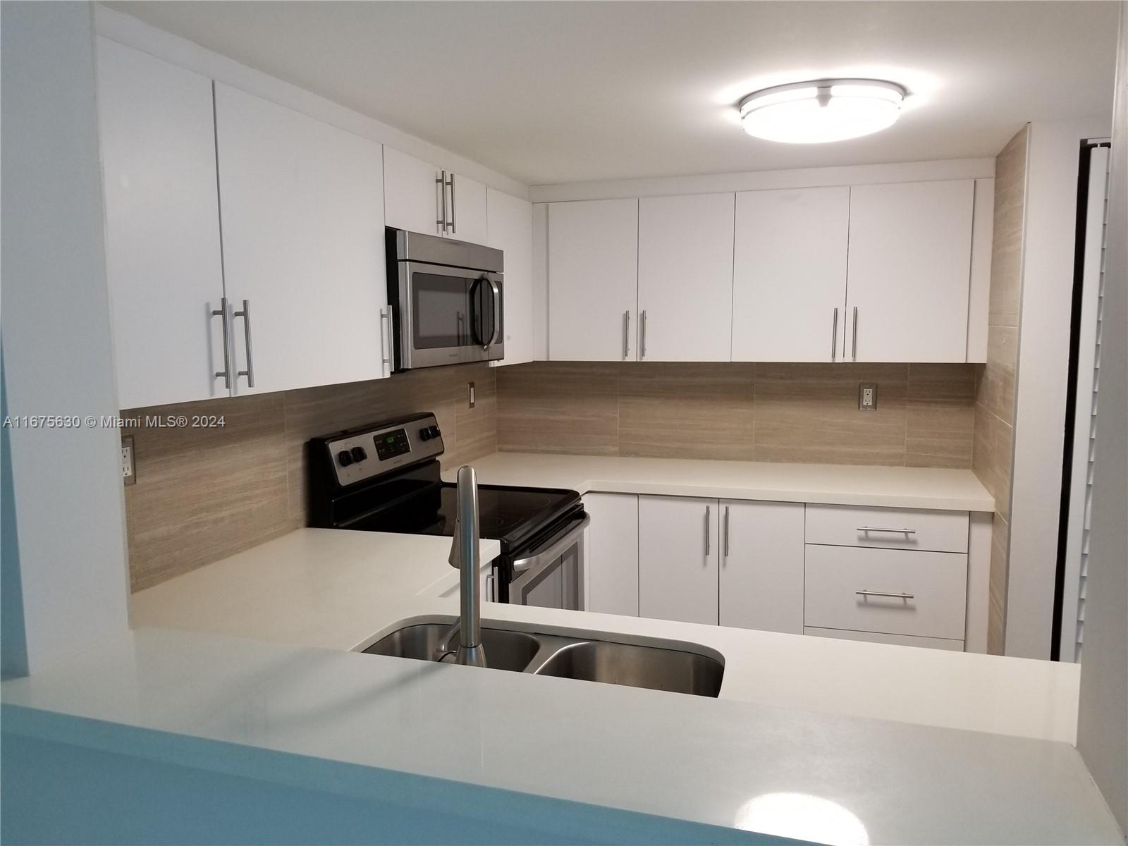 a kitchen with a sink and cabinets