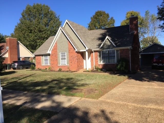 View of front of home featuring a garage and a front lawn